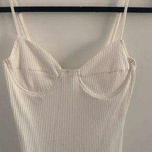 White ribbed body con dress. Wire bra cups. Adjustable straps. Never worn.
